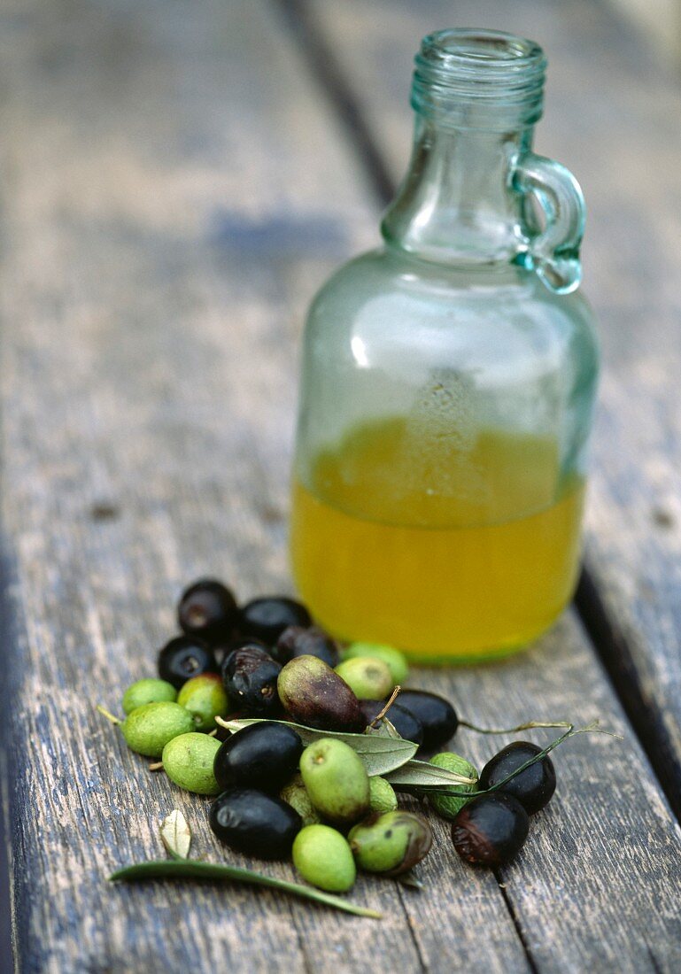 Oliven und eine Flasche Olivenöl
