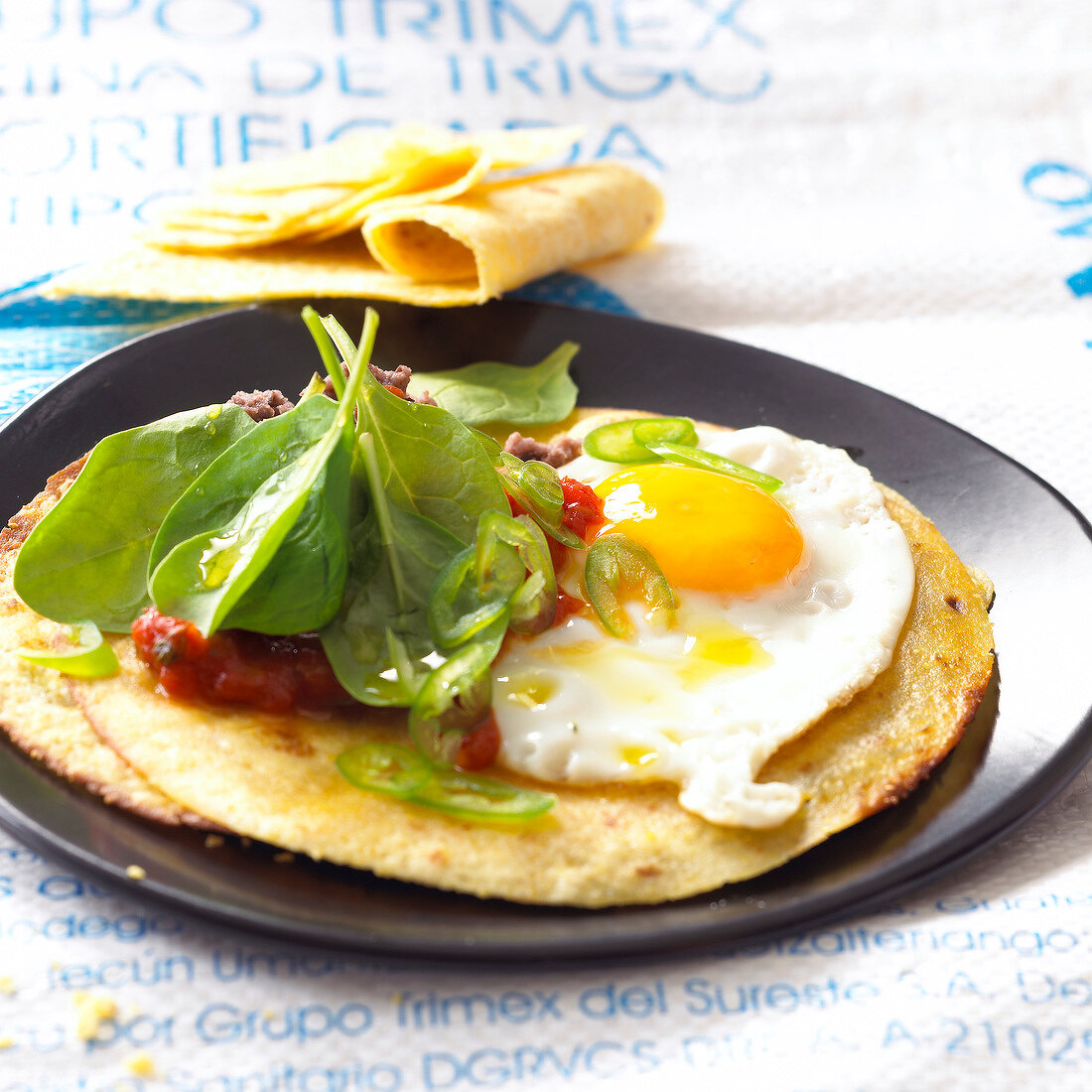 Savoury pancakes with fried egg,tomato and raw spinach