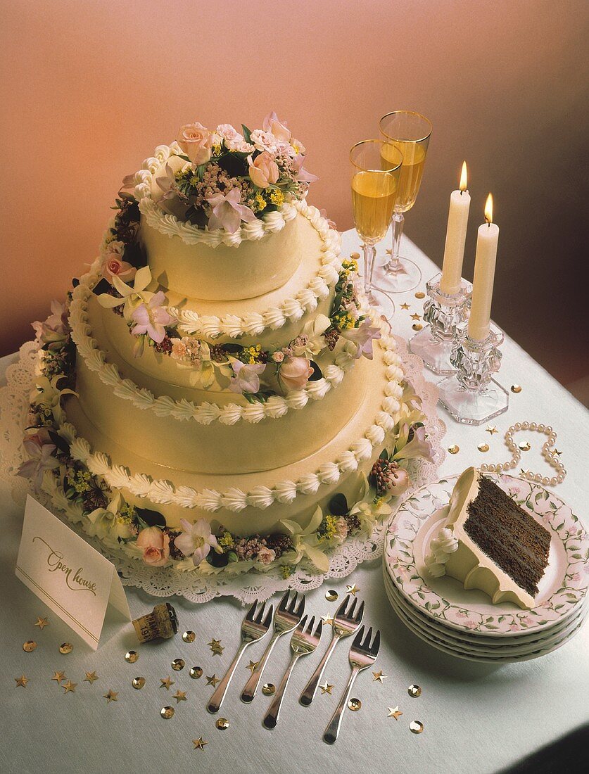 Four Tiered Wedding Cake with Fresh Flowers; Candlelight