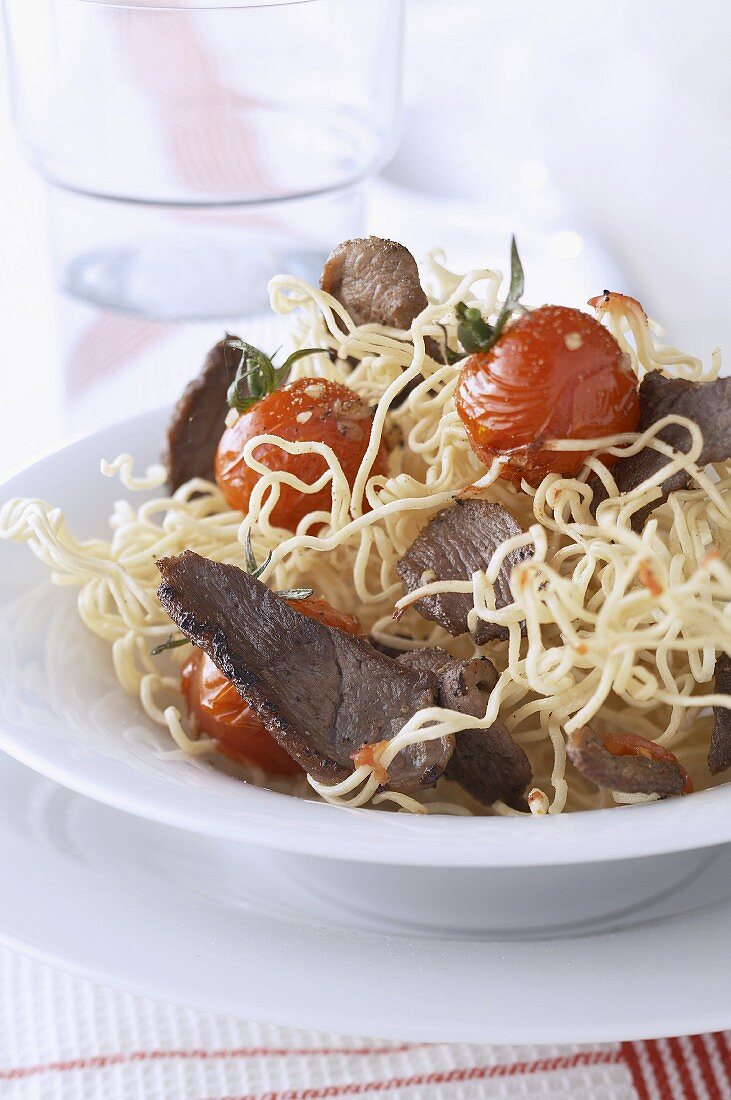 Sauteed duck and noodles with cherry tomatoes