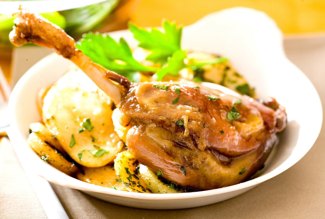 Duck leg with sauteed potatoes with chopped parsley