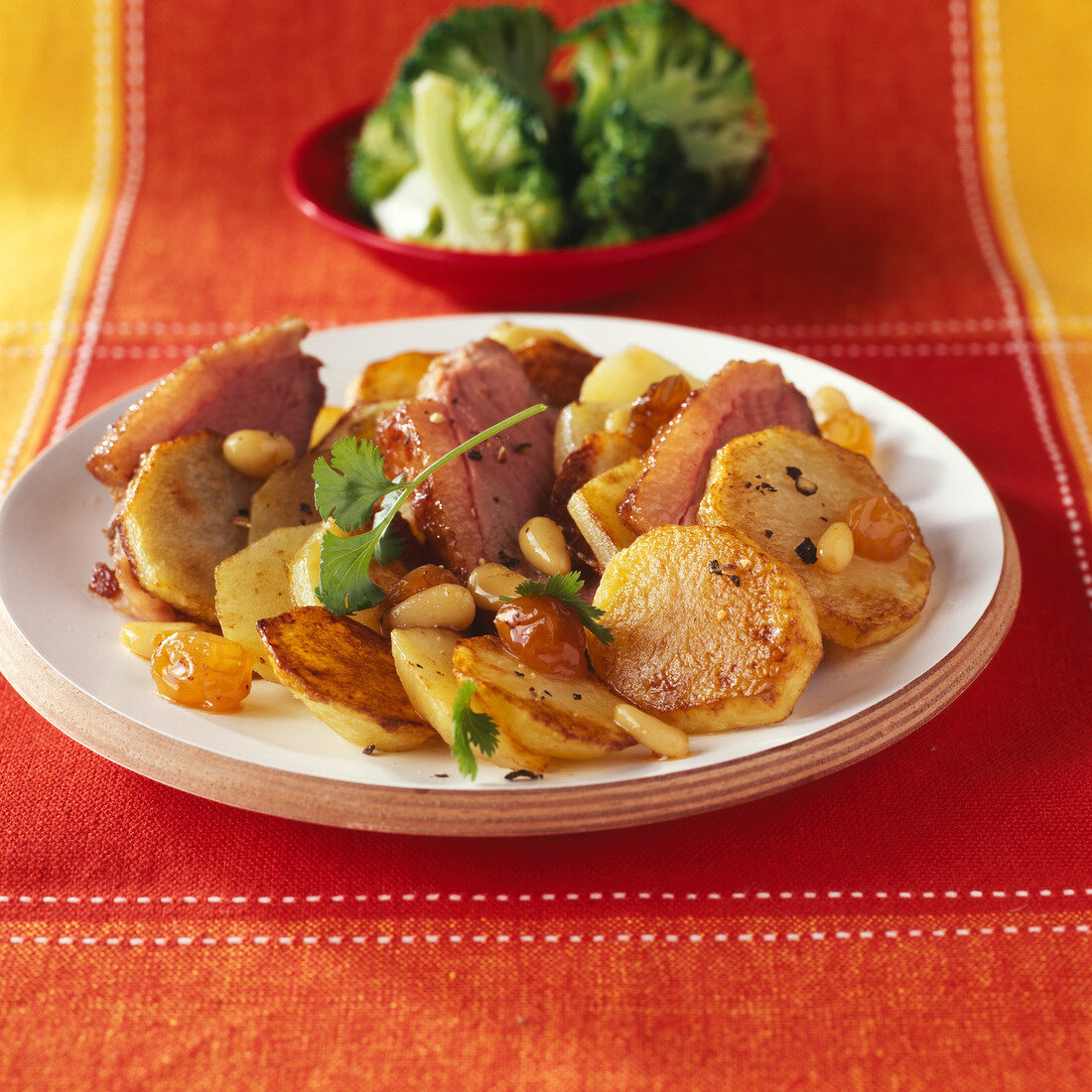 Sauteed potatoes with duck Magret ,raisins and pine nuts