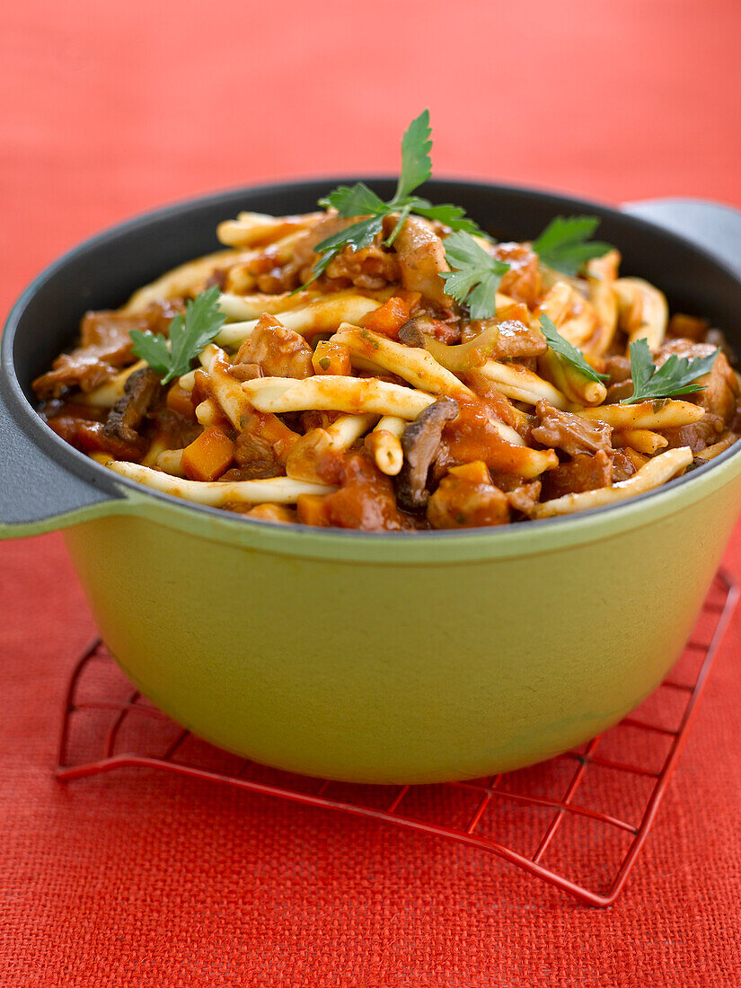 Pasta and rabbit stew in a casserole dish