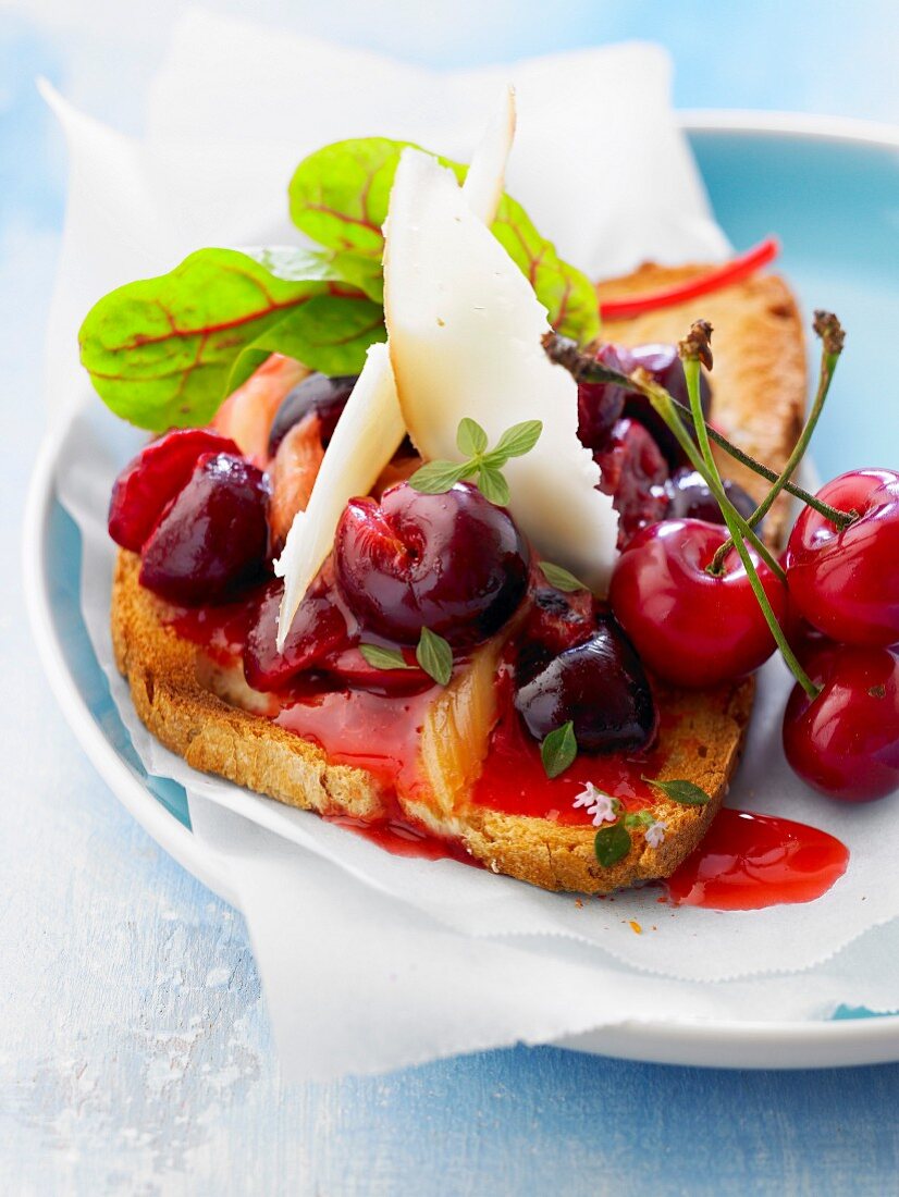 Stewed cherries,cheese and mesclun on toast