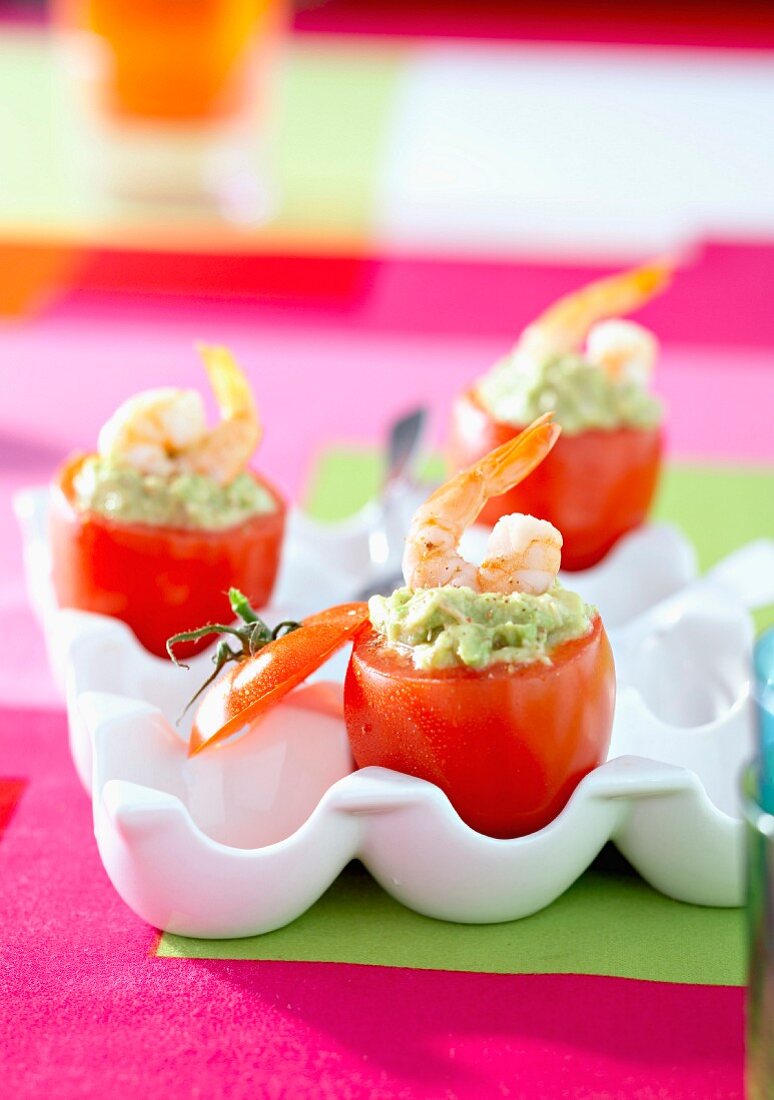 Tomatoes stuffed with guacamole and shrimps
