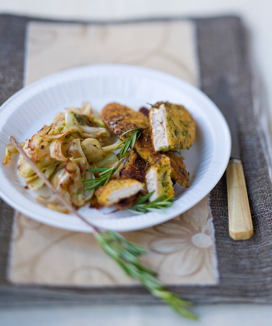 Sliced chicken breast coated with breadcrumbs and chicory