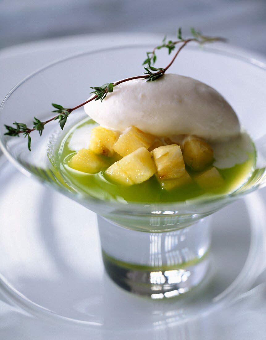 Cream of kiwi soup with diced pineapple and thyme-flavored ice cream
