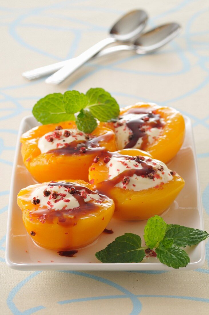 Poached peaches with cream and maple syrup