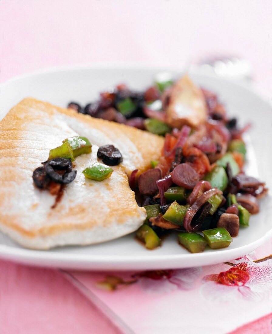 Tuna steak with tomatoes and olives