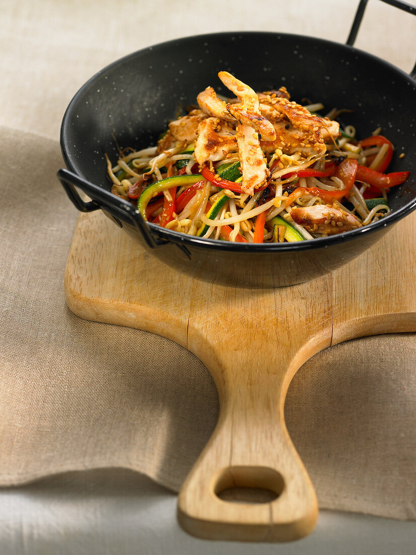 Sliced chicken,peppers and beansprouts sauteed in a wok