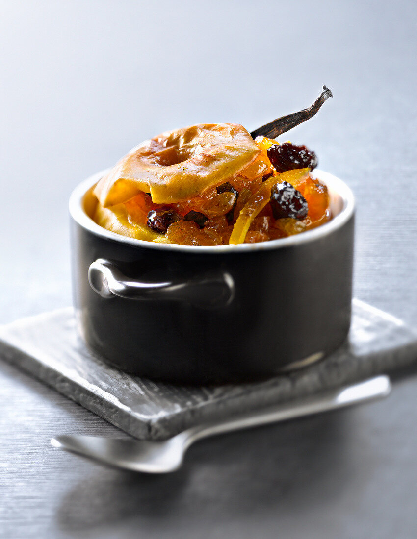 Casserole dish of baked apple with dried fruit and vanilla