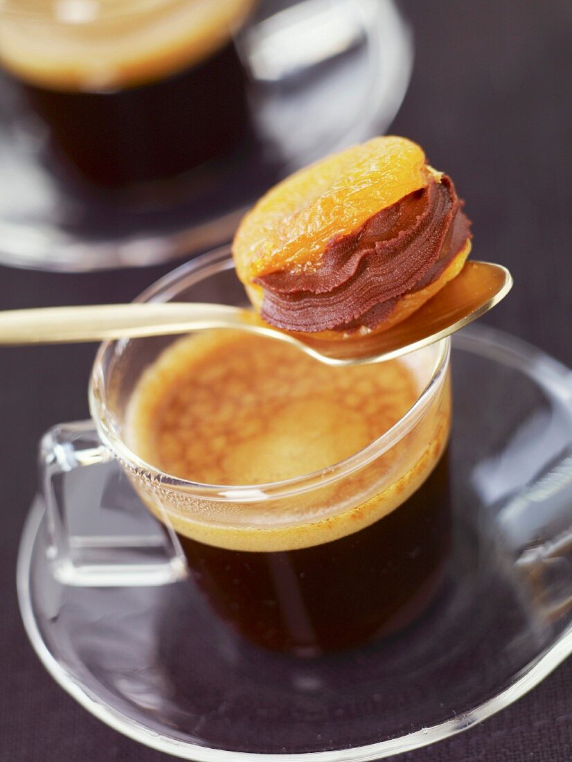 Dried apricot with chocolate filling and a cup of coffee