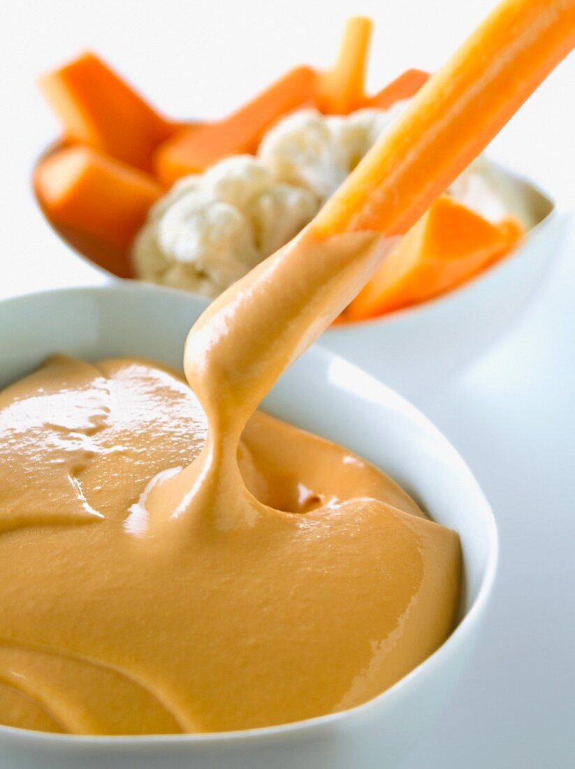 Raw carrot dipped in cocktail sauce