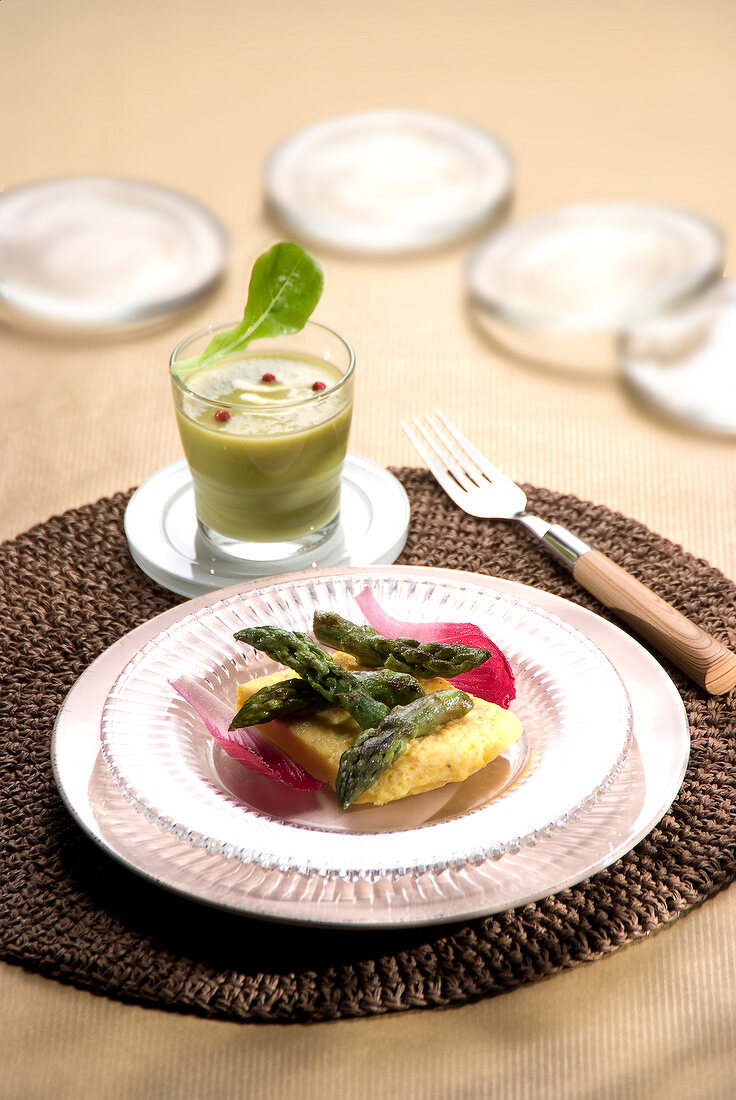 Cream of asparagus and green asparagus tops with scrambled eggs