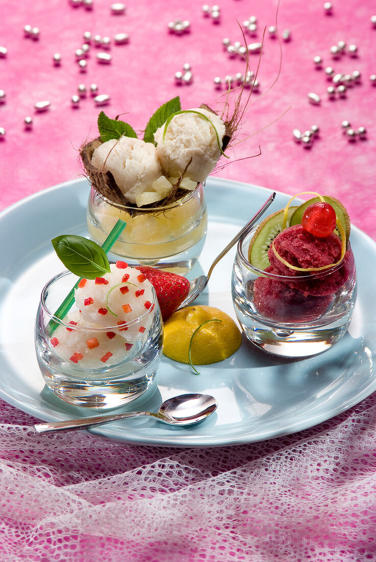 Three sorbets : basil with pieces of strawberry, all season cherry and coconut-pineapple