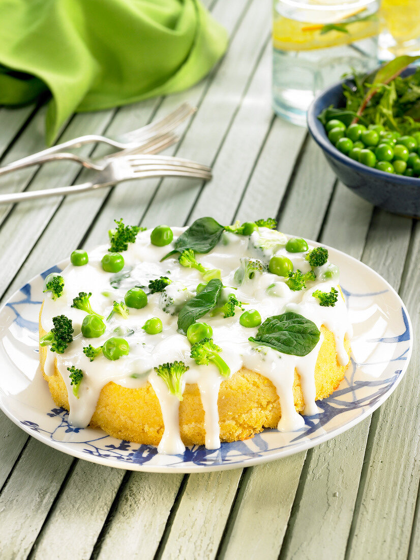 Soya and corn cake coated with cream and green vegetables