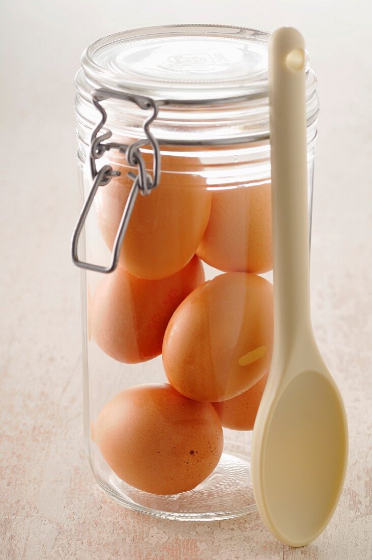 Jar of eggs and a wooden spoon