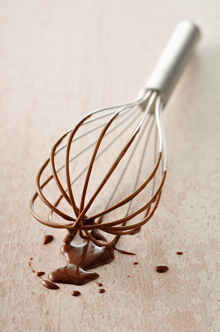 Whisk covered in chocolate Fondue
