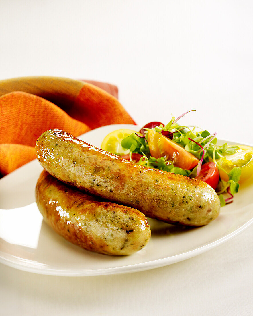Grilled sausages with vegetable salad