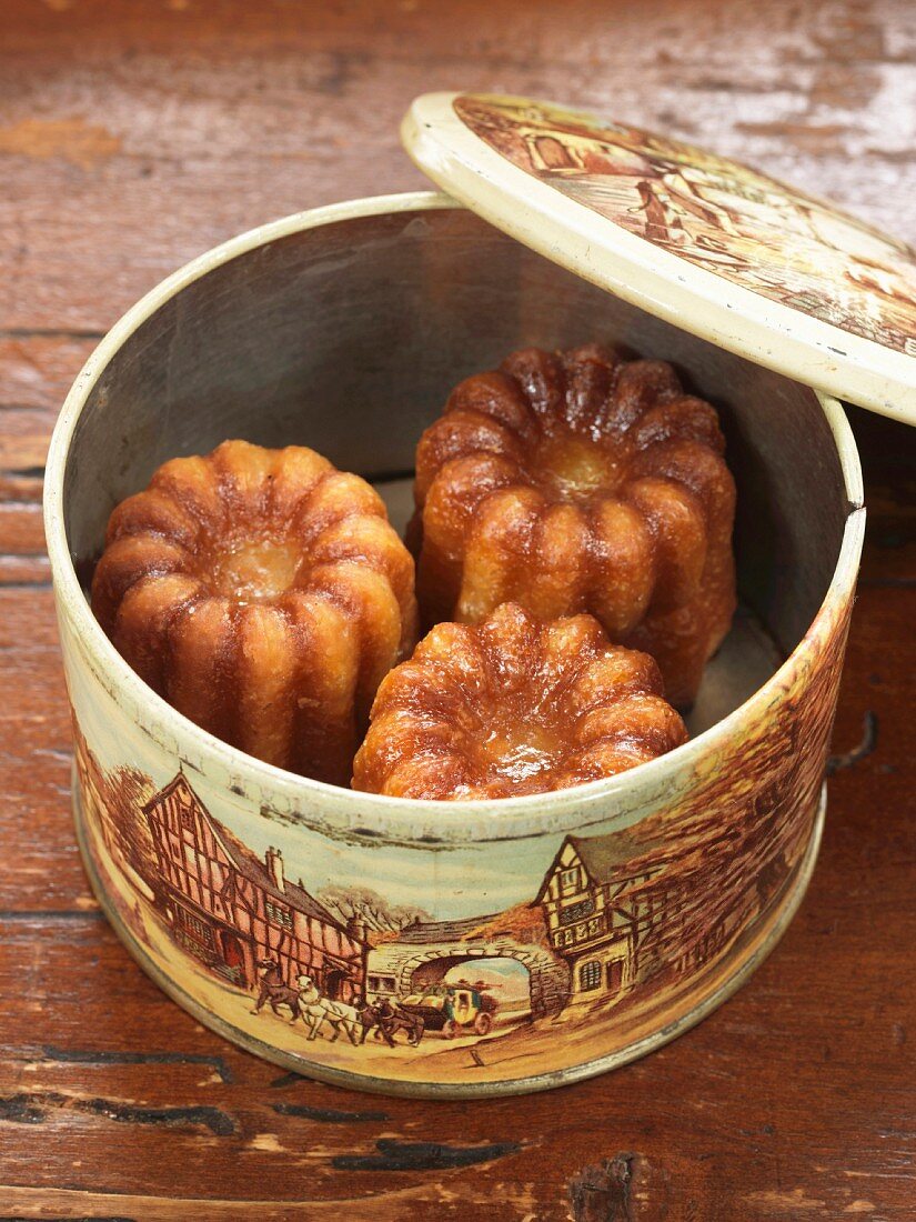 Cannelés (Traditionelle Karamellküchlein aus Bordeaux) in einer Blechdose