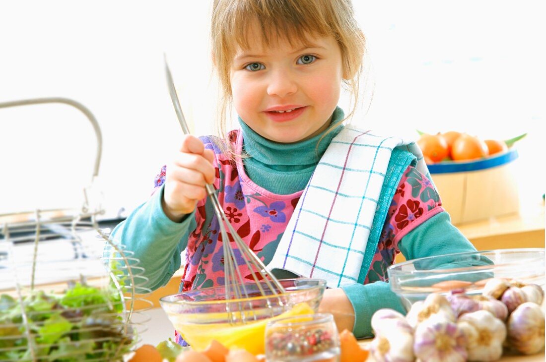 Young girl beating eggs