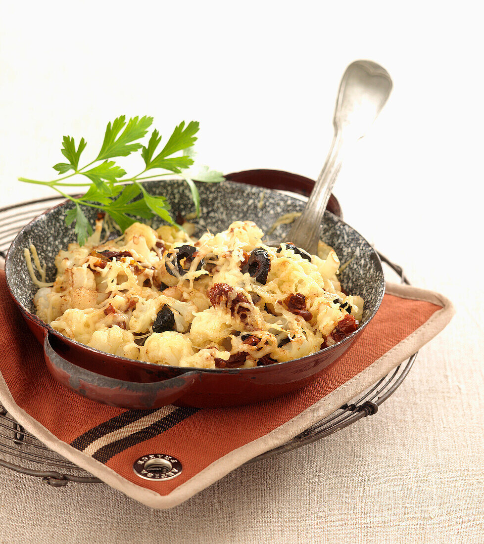Cauliflower, olive and emmental cheese-topped dish