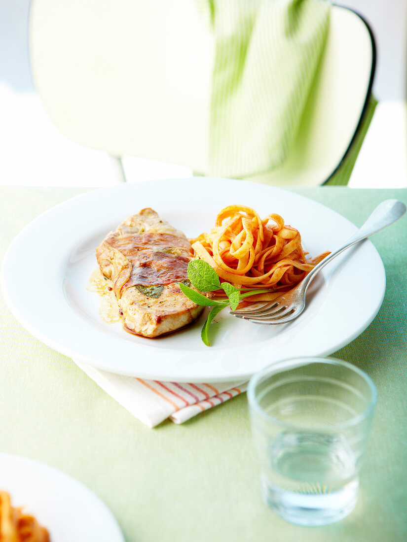 Pork escalope with Prosciutto and tagliatelles in tomato sauce