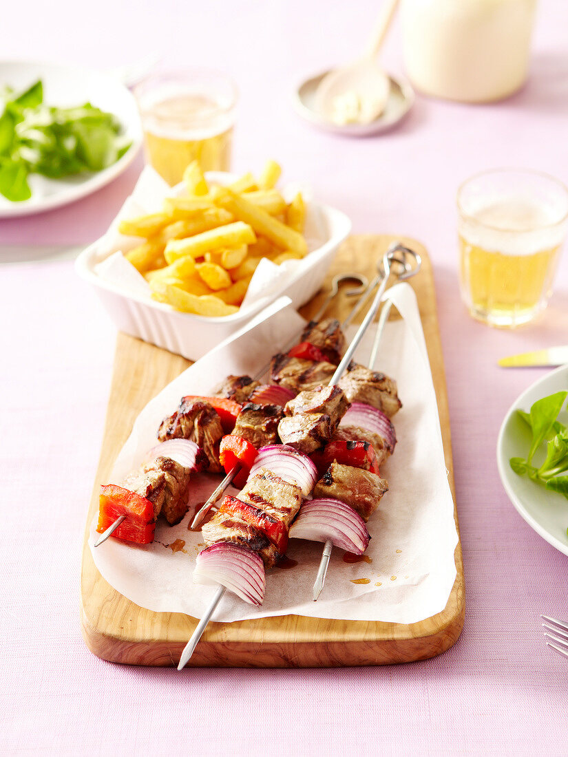 Beef,onion and red pepper skewers with french fries