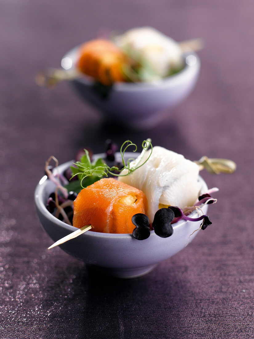 Mixed shoot salad with halibut and salmon appetizers