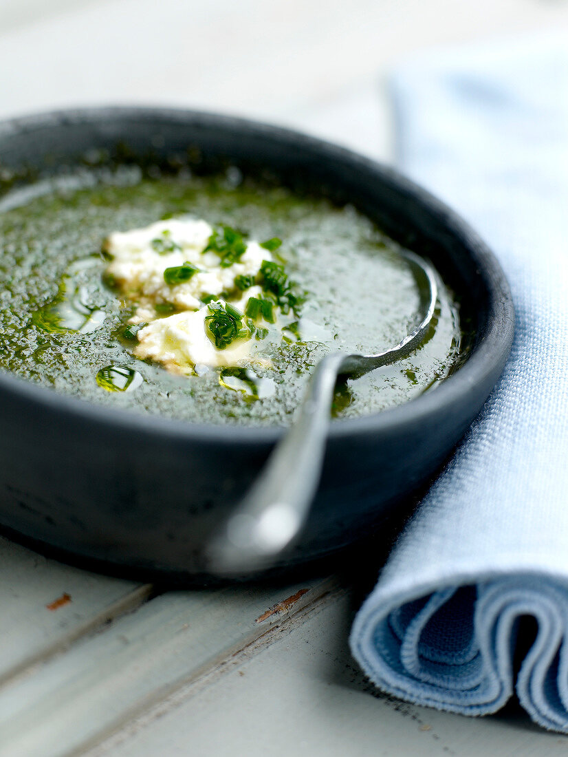 Bitter herb soup with goat's cheese Brousse