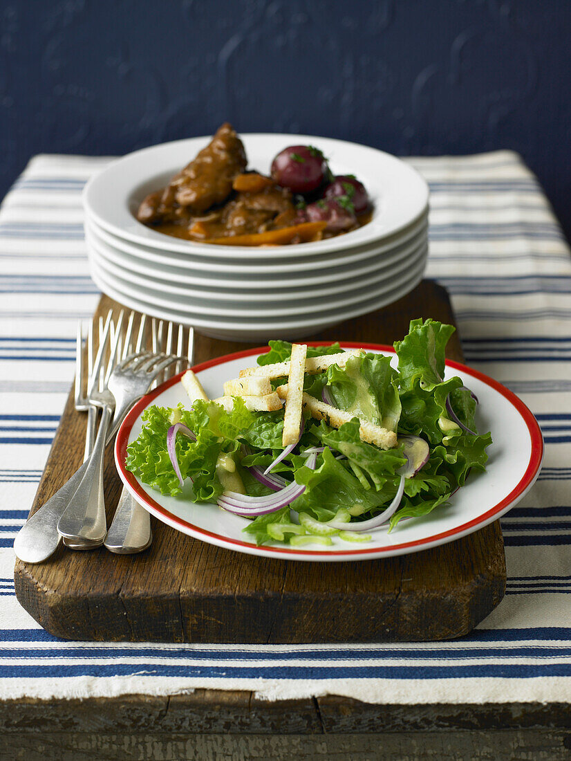 Lettuce,red onion and bread stick salad, beef and carrot stew