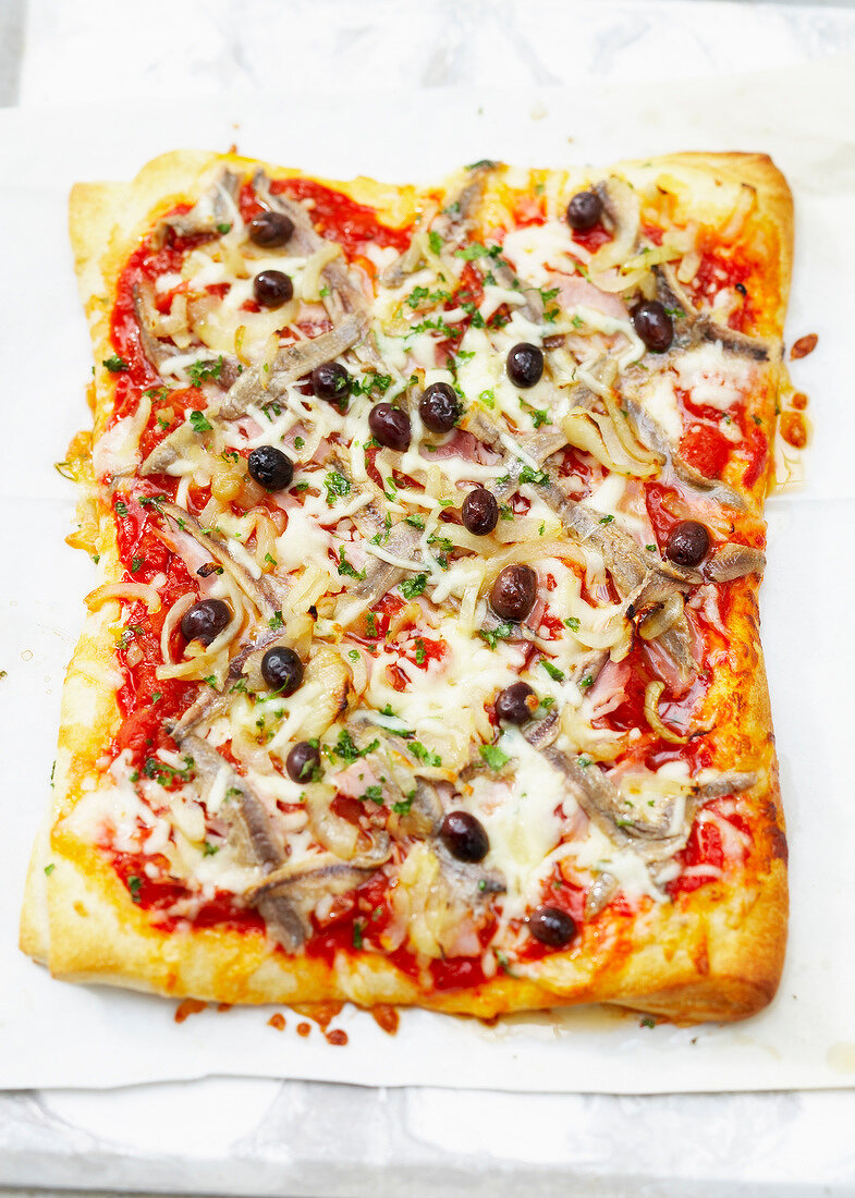 Family size pizza with anchovies and black olives