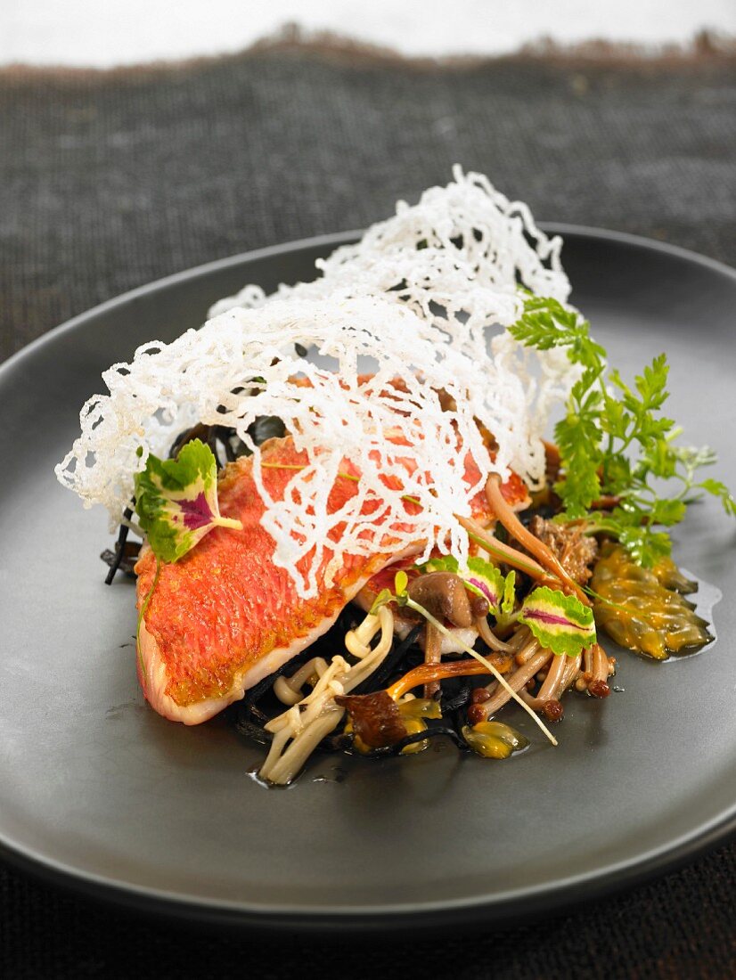 Red mullet fillets with noodles, mushrooms, passion fruit and seaweed