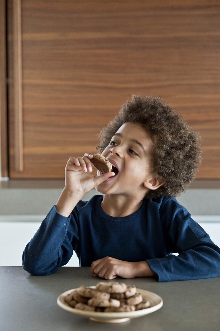Young boy eating a cookie