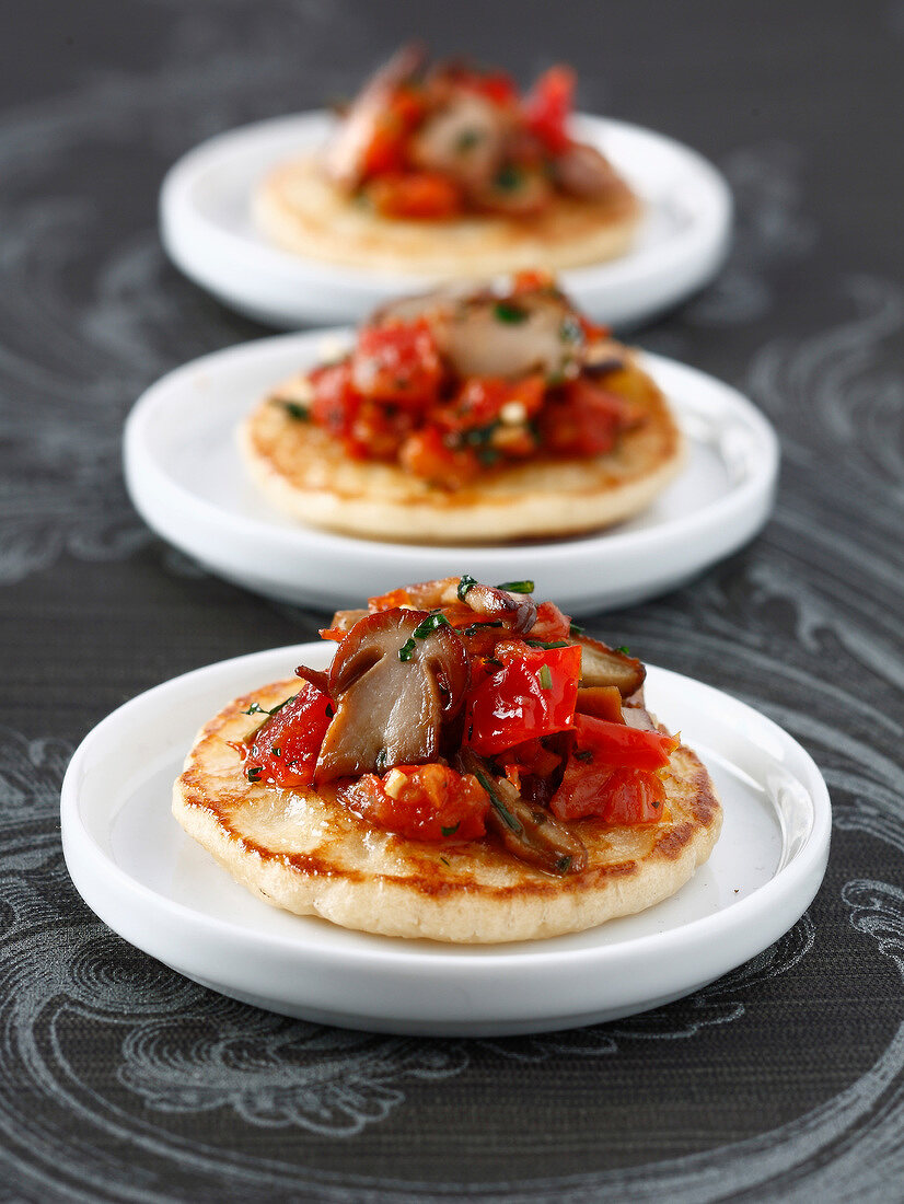 Blinis with ceps and tomatoes