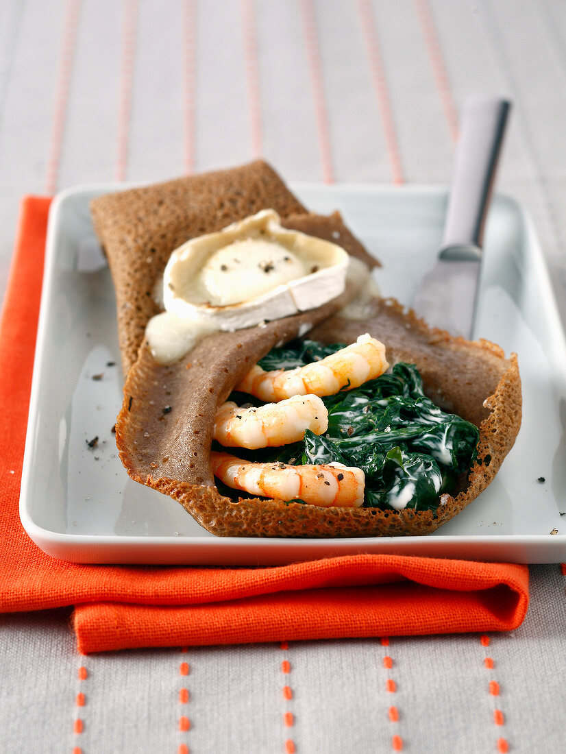 Buckwheat pancake with spinach, seafood and goat's cheese