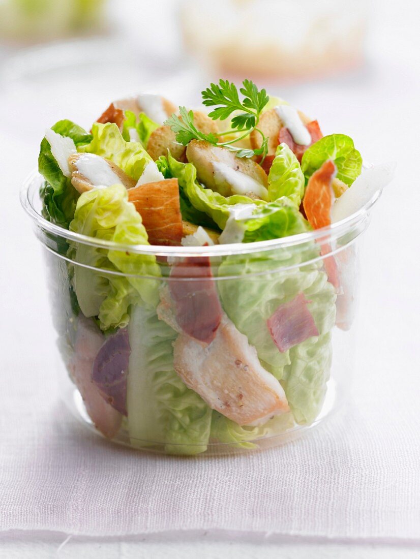 Caesar salad in a plastic container