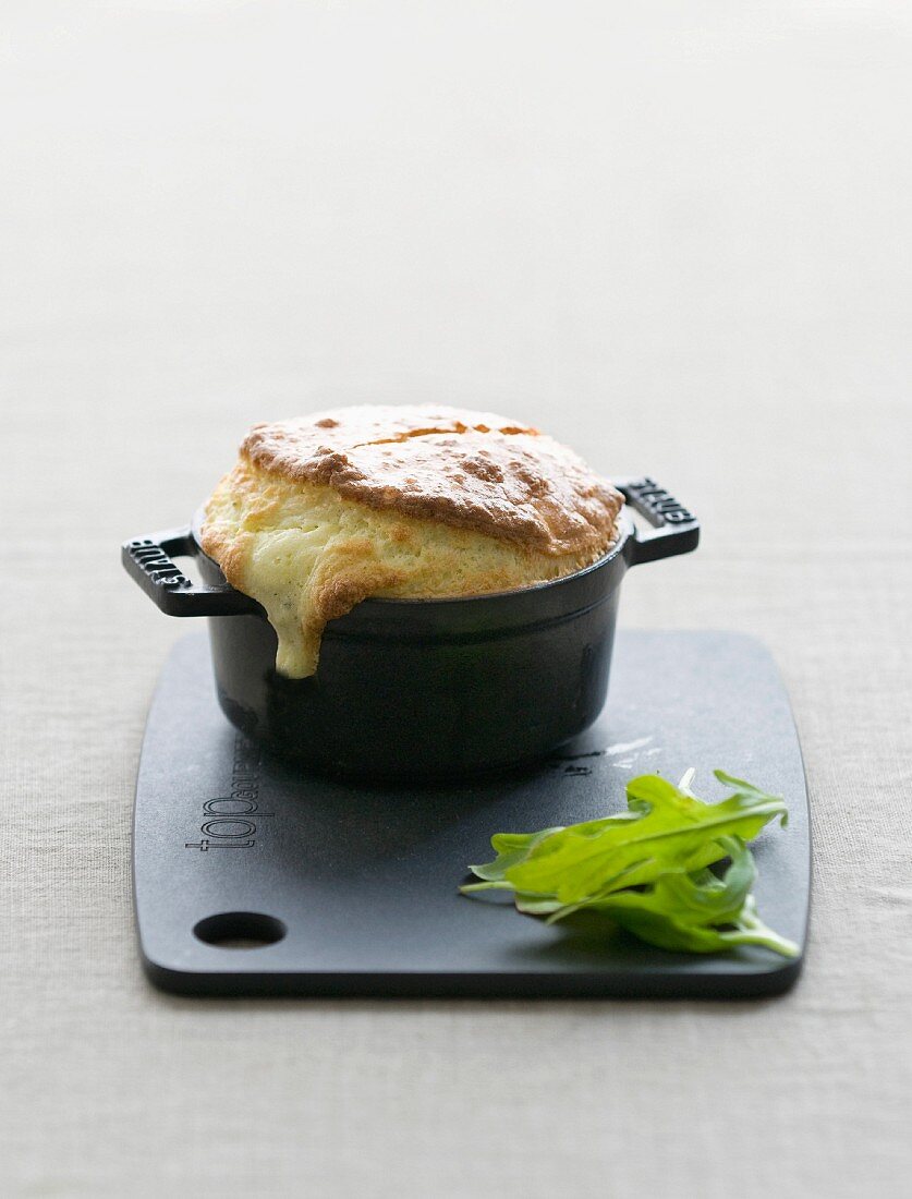 Cheese soufflé served in a small casserole dish