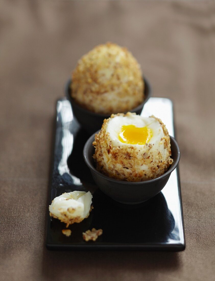 Soft-boiled eggs coated in crushed hazelnuts