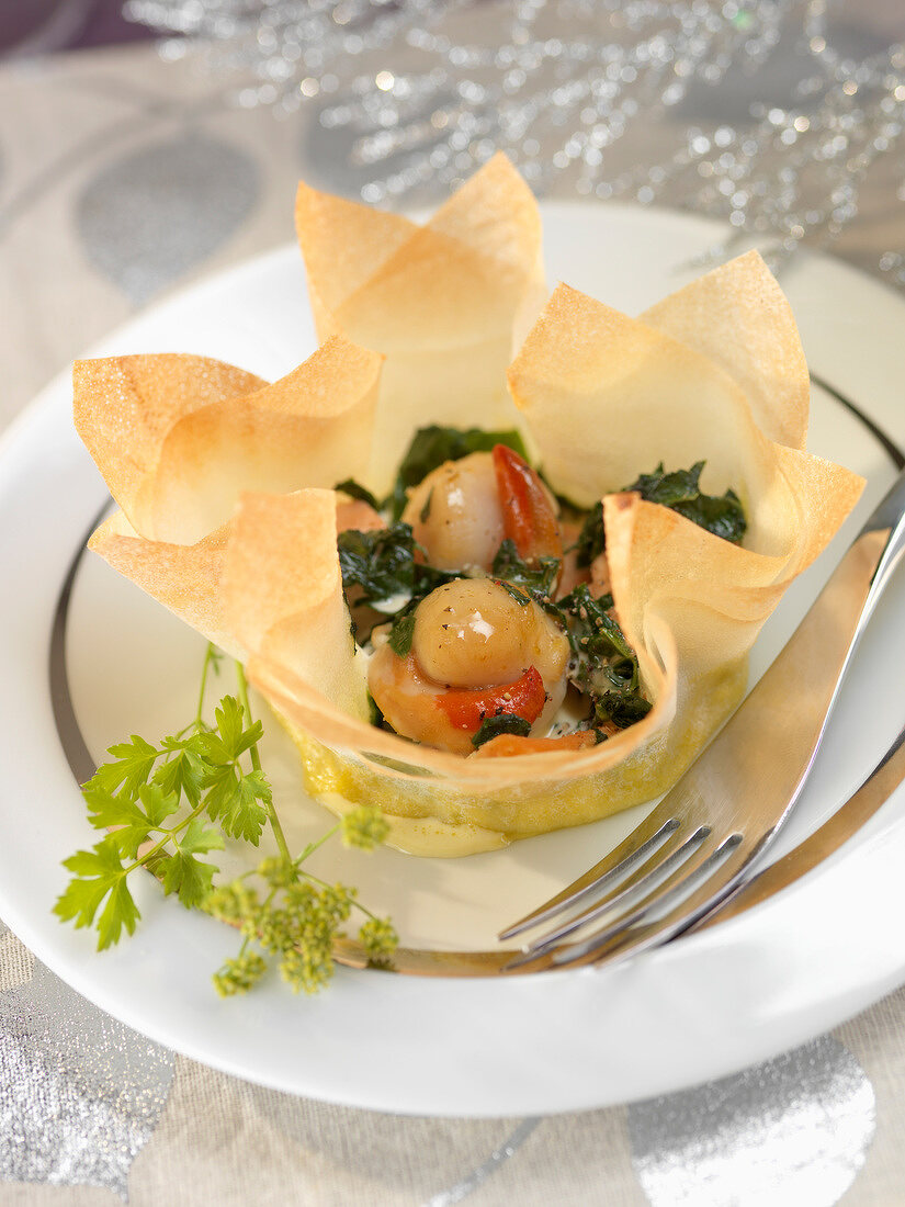 Scallops and salmon cooked in a filo pastry casing