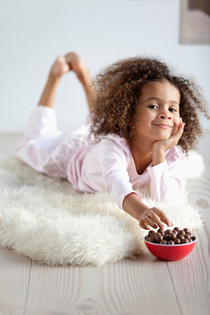 Young girl eating candies