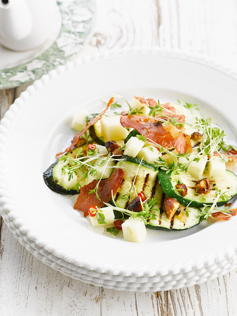 Warm zucchini and eggplant salad with almonds and chili peppers