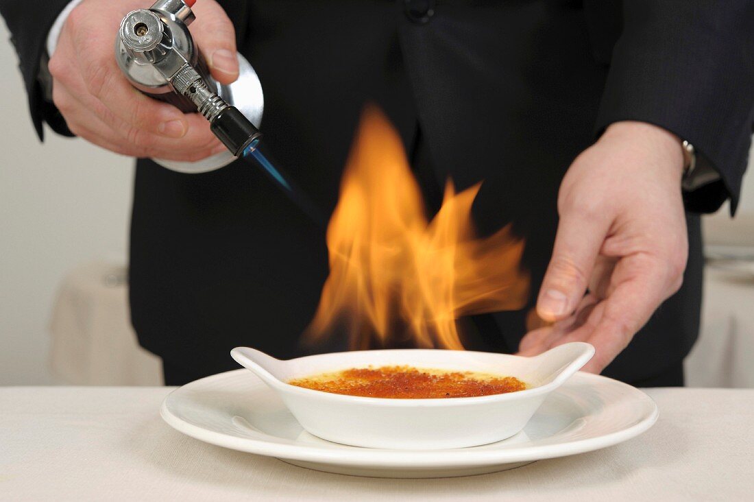 Caramelizing a Crème brûlée with a blowtorch