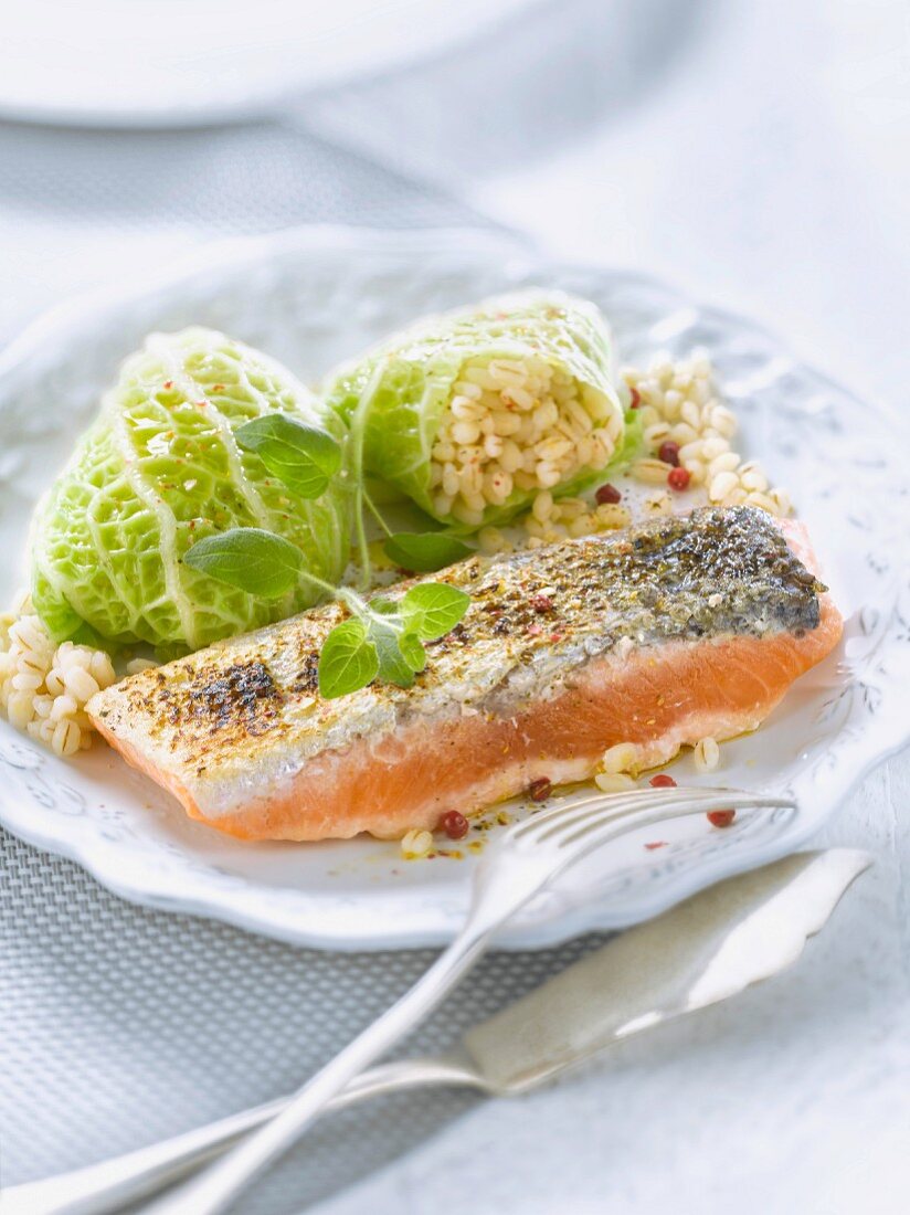 Thick piece of salmon and cabbage stuffed with barley