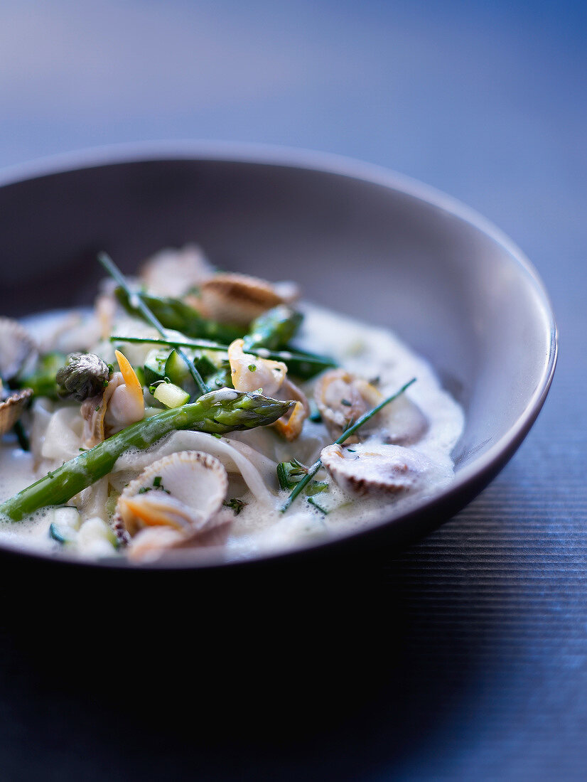 Cockle and green asparagus raviolis, thyme and zucchini emulsion