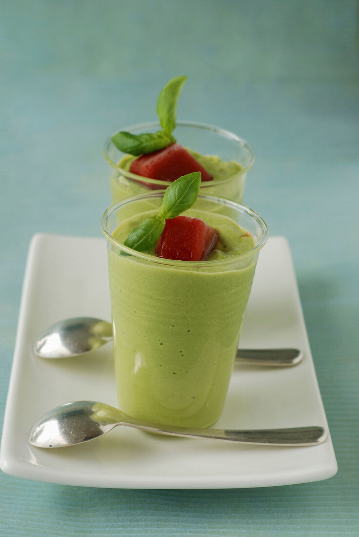 Cream of avocado and rocket lettuce, basil leaves and tomato-flavored ice cube