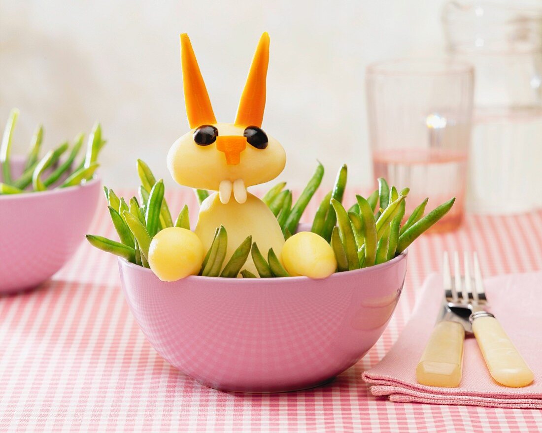 Potatoes,carrots and green beans in the shape of a rabbit in the grass