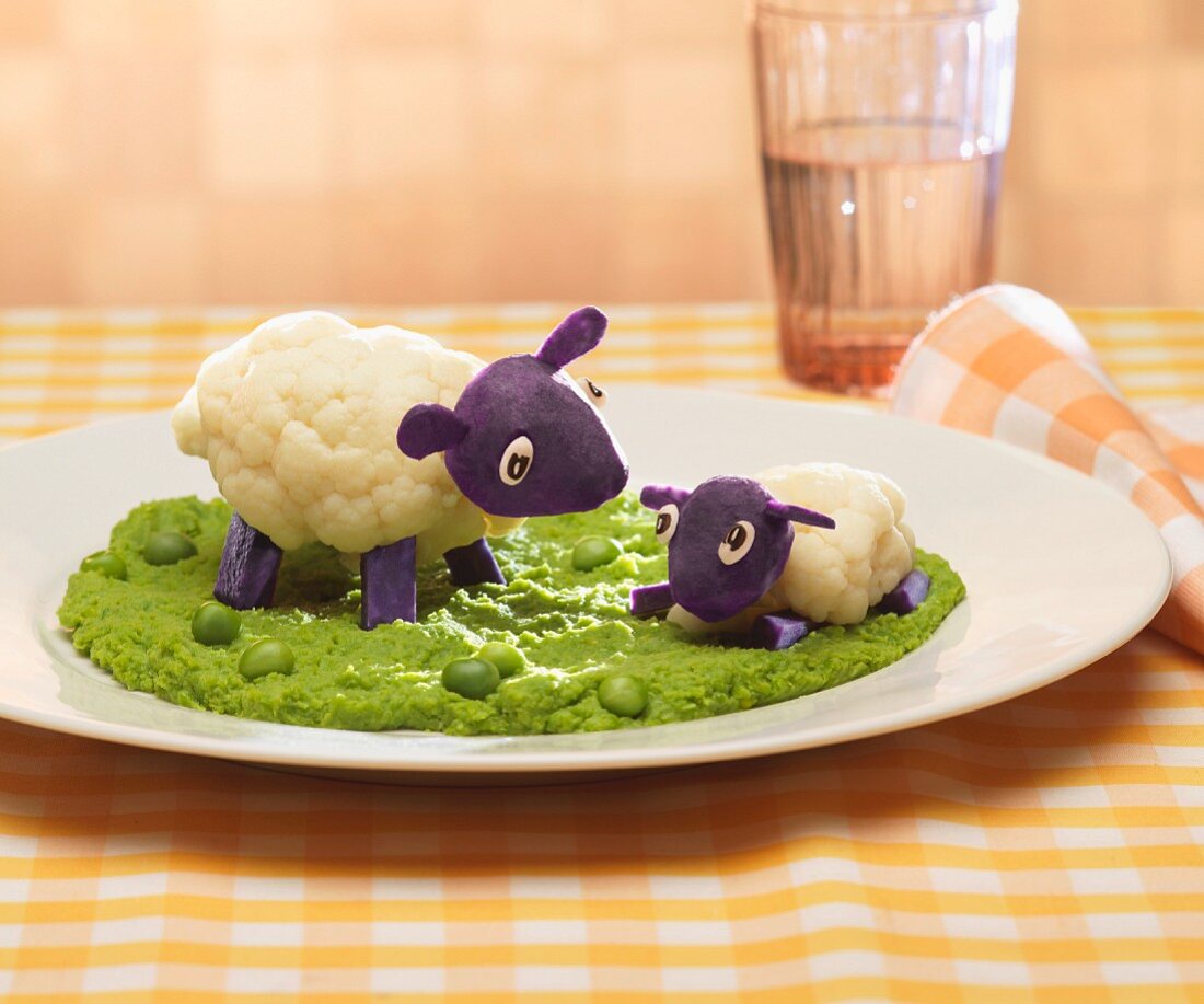 Cauliflower,purple potato and pureed pea dish representing sheep in a field