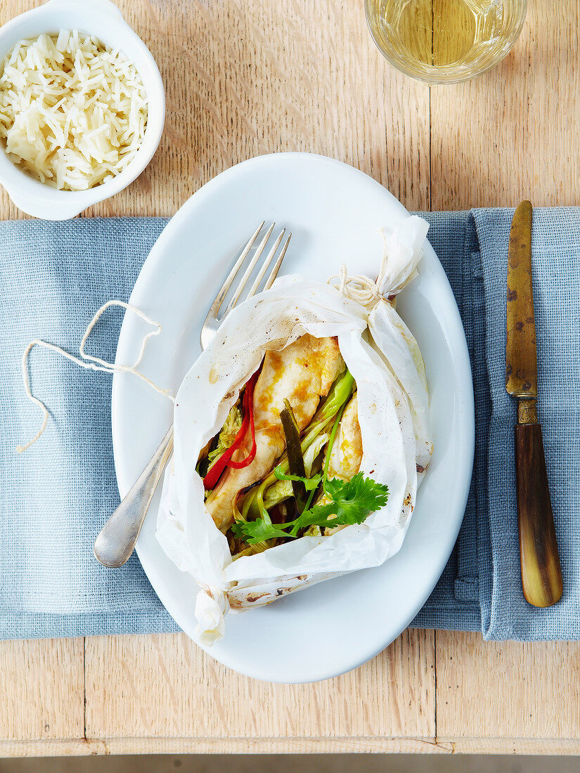 Thai-style chicken with citronella cooked in wax paper,white rice