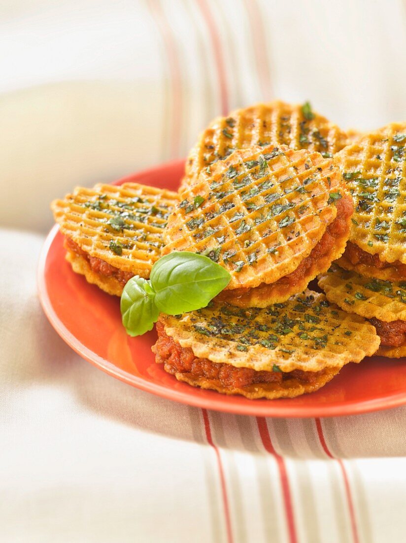Basil and olive oil waffle cookie sandwiches filled with sun-dried tomato cream
